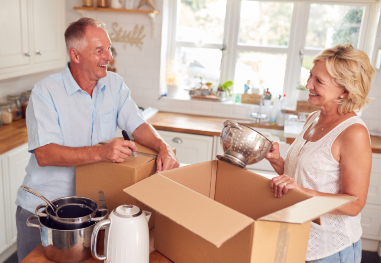 two people unpacking kitchen supplies