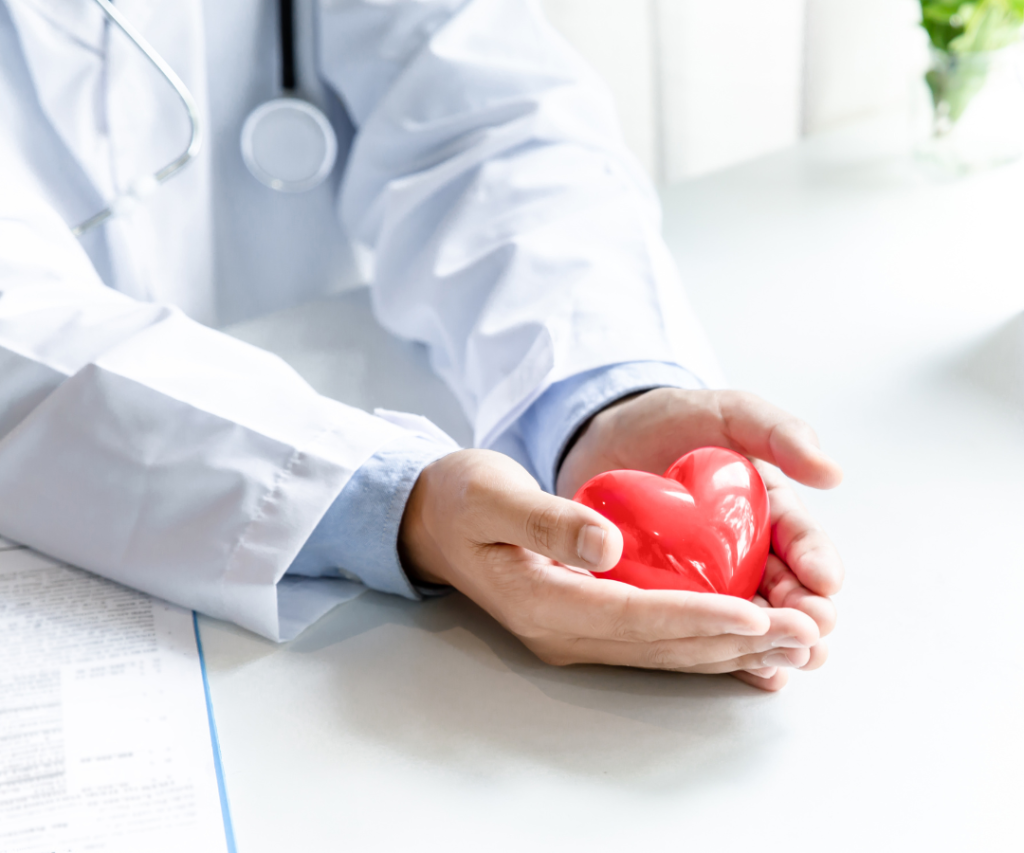 a doctor holding a plastic love heart