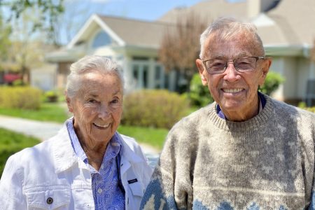 two people smiling outside